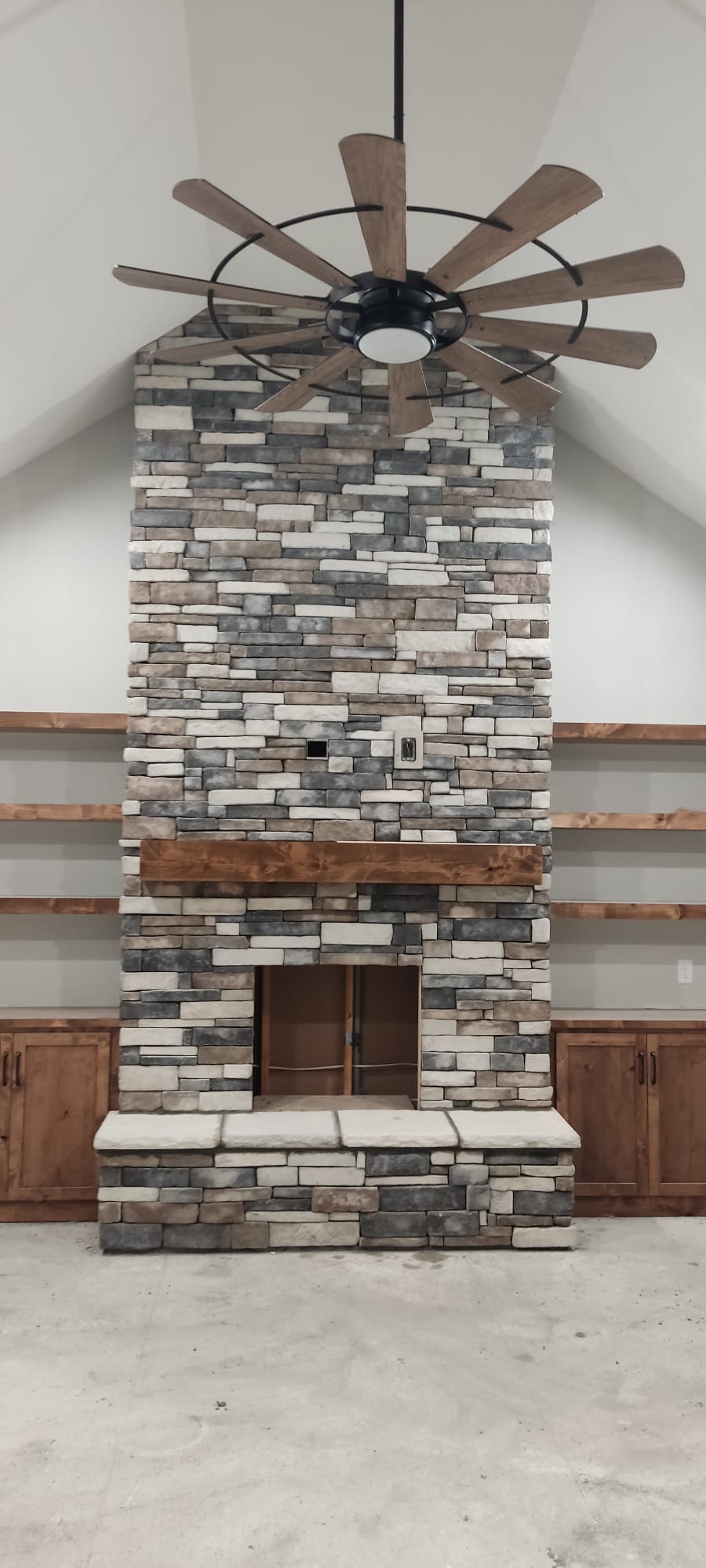 living room chimney and fireplace limestone and large vaulted ceilings with beautiful fan